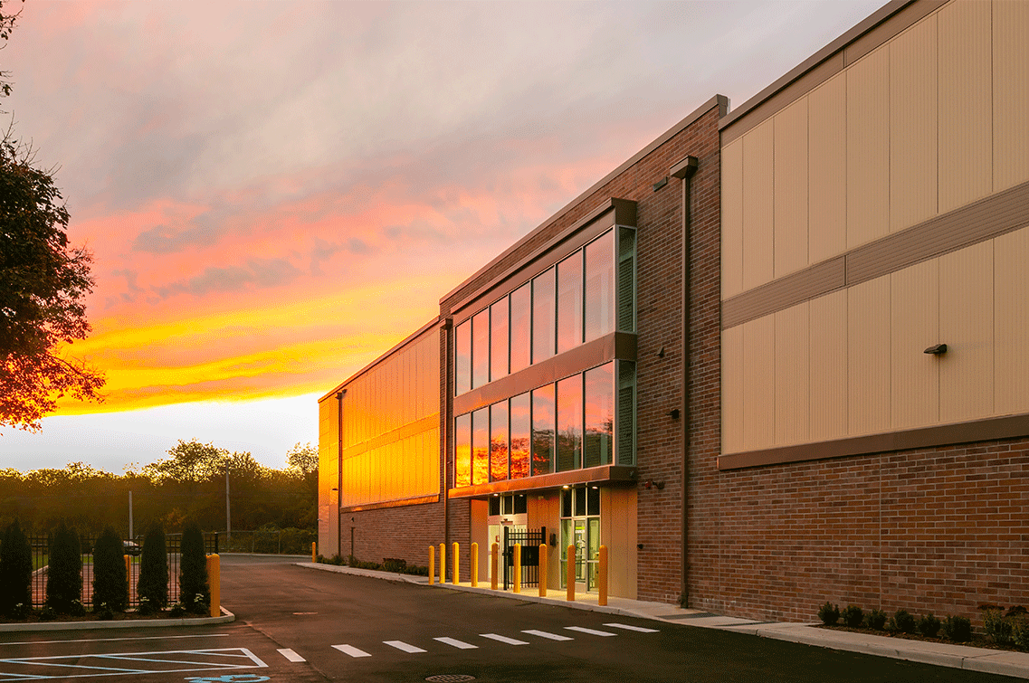 Image{width=1137,height=755,url='https://8488932.fs1.hubspotusercontent-na1.net/hubfs/8488932/HuntingtonGallery-3.png',altText='A ground shot of DXD Capital's self storage facility at sunset. The angle is to the right of the front of the building and shows the entrance from the parking lot. ',fileId=null}
