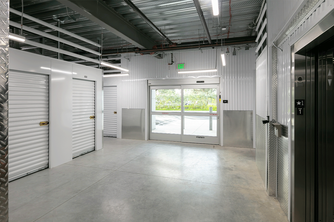 Image{width=1137,height=755,url='https://8488932.fs1.hubspotusercontent-na1.net/hubfs/8488932/N-DoralGallery-4.png',altText='An interior image of the brightly-lit entrance of DXD Capital's N. Doral self storage facility in Miami, FL. The photo shows a set of automatic glass doors, the entrance to the freight elevator and white roll down doors on the units.',fileId=null}