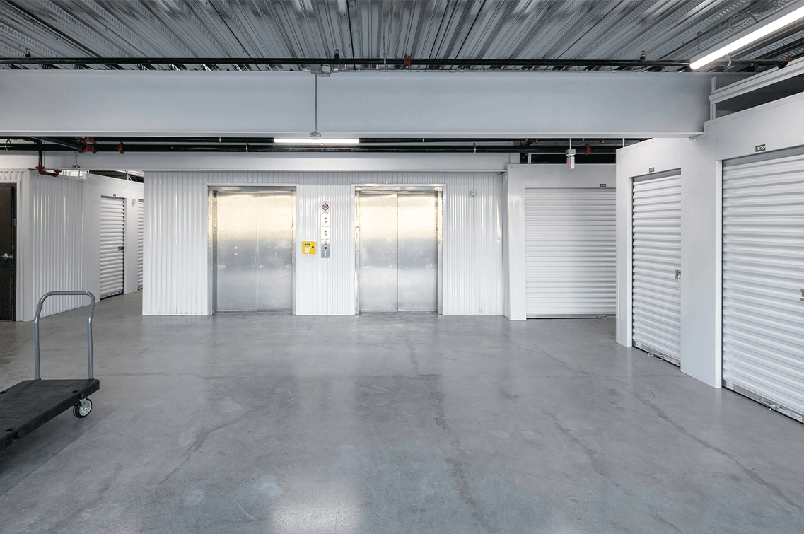 Image{width=1137,height=755,url='https://8488932.fs1.hubspotusercontent-na1.net/hubfs/8488932/ScottsdaleGallery-4.png',altText='An interior shot of the brightly lit entry bay of DXD Capital's Scottsdale storage facility. There are two large freight elevator doors in the foreground and white roll-down unit doors on either side.',fileId=null}
